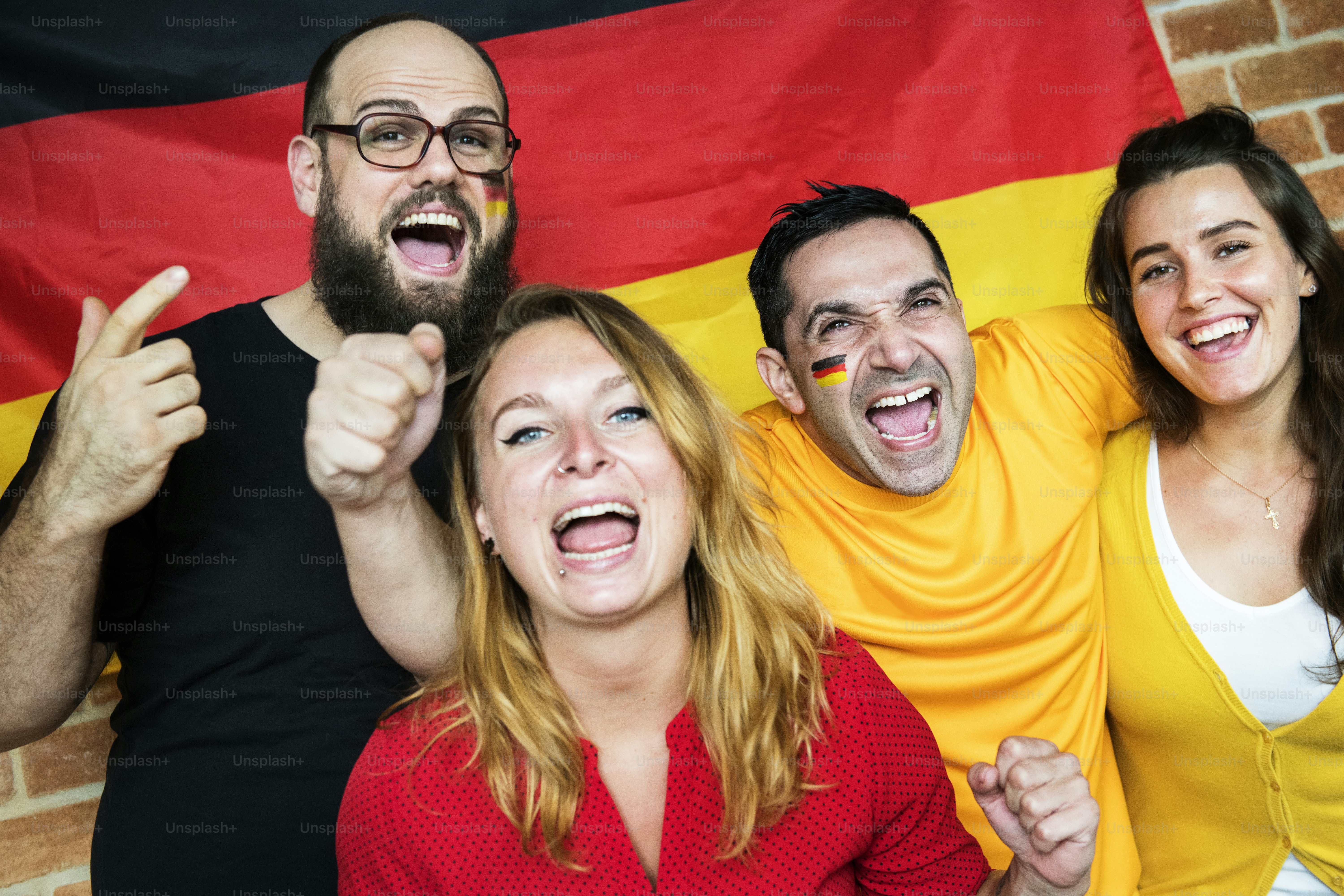 Friends cheering world cup with painted flag